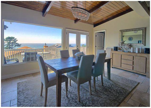A dining room with a view of the ocean.