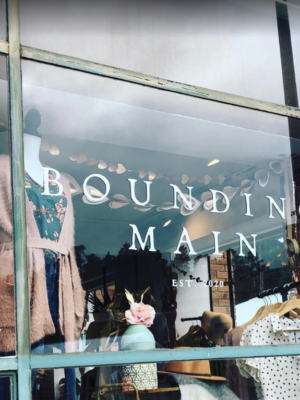 shop window with word "bounding main" printed in white