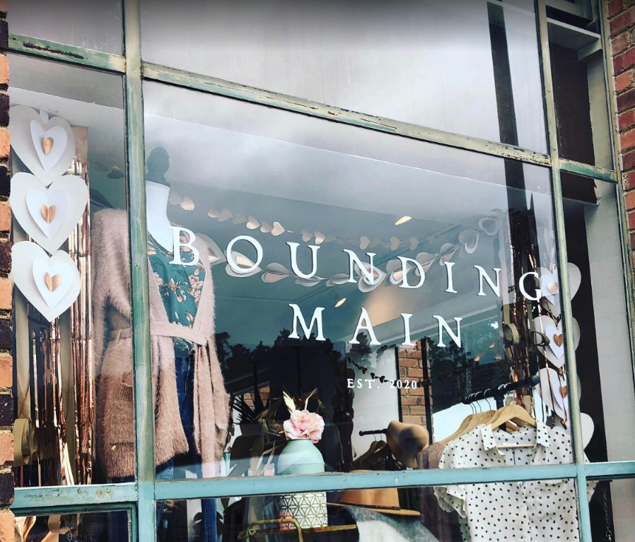 shop window with word "bounding main" printed in white